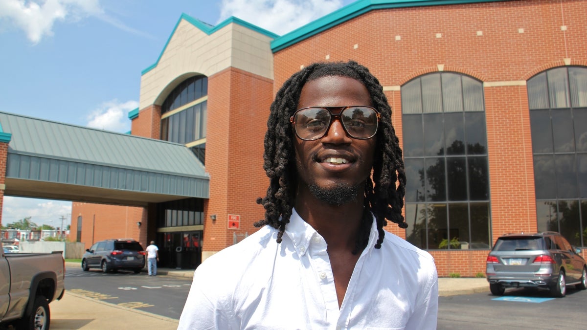 Elijah Clay stands outside the Deliverance Evangelistic Church in North Philadelphia, where he works and studies theology.