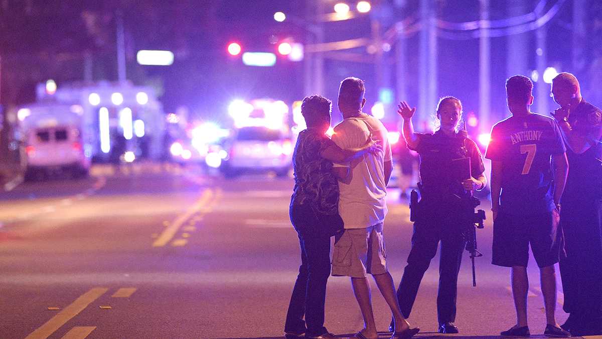   Orlando Police officers direct family members away from a fatal shooting at Pulse Orlando nightclub in Orlando, Fla., Sunday, June 12, 2016. (Phelan M. Ebenhack/AP Photo)  