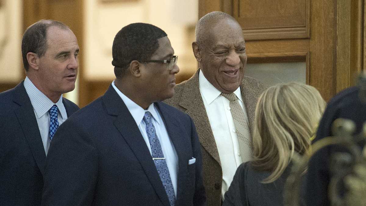 Bill Cosby leaves the courtroom with the help of an aide flanked by lawyer Brian McMonagle (far left) with fellow counsel Angela Agrusa (right) during a break at the Montgomery County Courthouse in Norristown