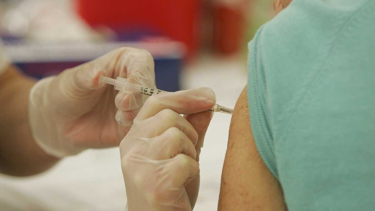 A person receives a flu shot