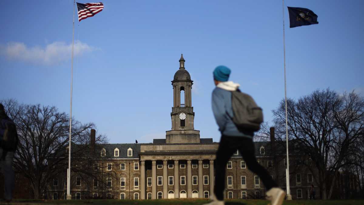  A student walks in front of the Old Main building on the Penn State campus. (Matt Rourke/AP Photo, file) 