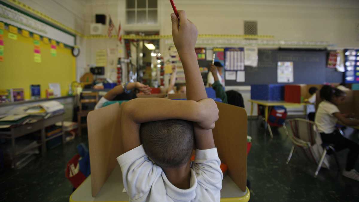  A student raises his hand at Isaac Sheppard School in Philadelphia. (Photo by Jessica Kourkounis) 