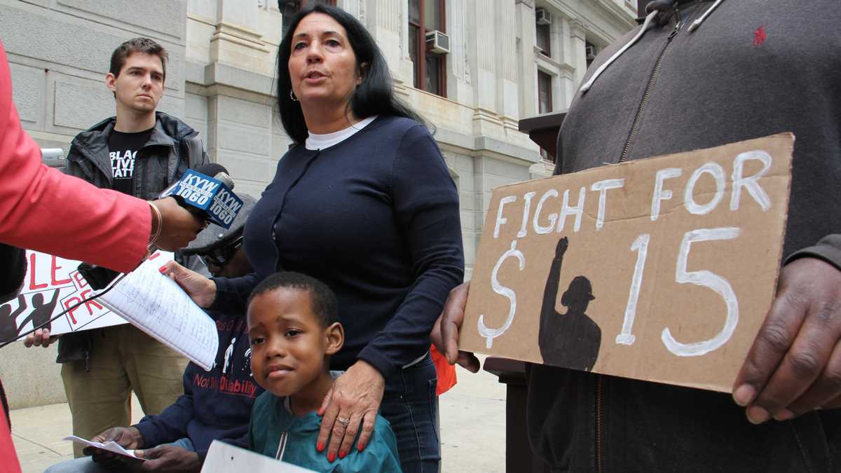  Cheri Honkala, national coordinator for the Poor People's Economic Human Rights Campaign, speaks with reporters outside City Hall (Emma Lee/WHYY) 