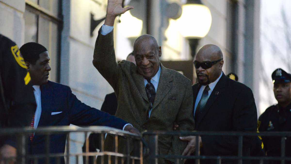 Bill Cosby smiles and waves while leaving the courthouse February 4