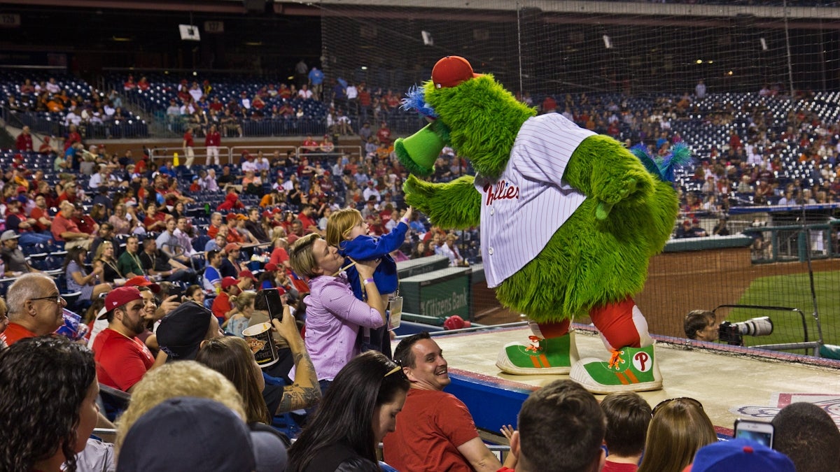  A young fan high-five's the Phillie Phanatic (Kimberly Paynter/WHYY) 