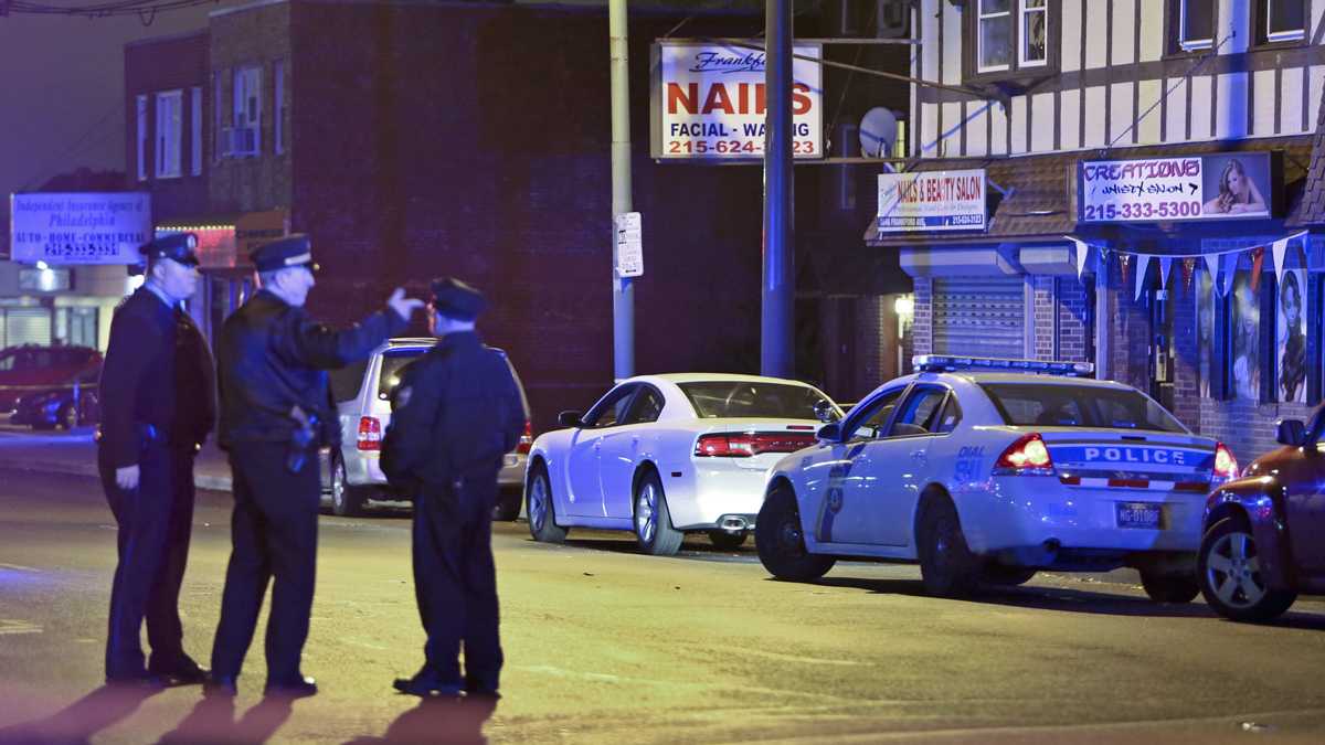  Investigators gather at the crime scene in the Mayfair section of Philadelphia, Monday Dec. 15, 2014, after an officer fired their weapons at a man. (AP File Photo/Joseph Kaczmarek) 