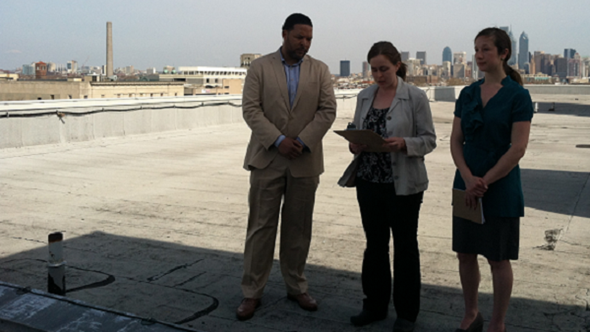  In April, South Philadelphia HS Principal Otis Hackney, Kim Massare of the Lower Moyamensing Civic Assn. and Lauren Mandel from Roofmeadow landscape architecture firm stood on what could become a rooftop farm. (Emma Jacobs/WHYY) 