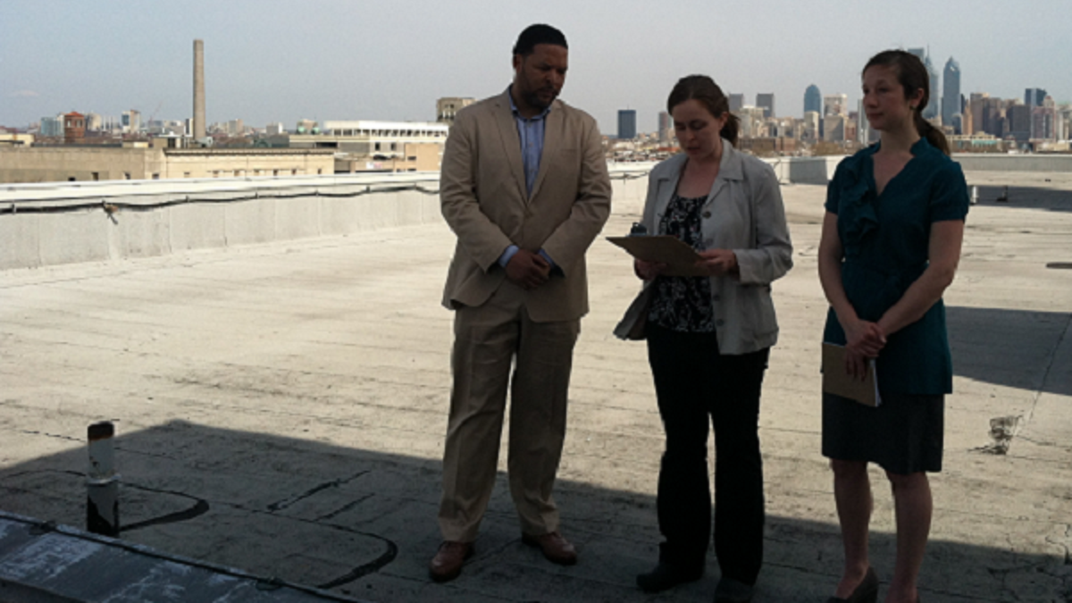 l_roof600-2 In April, South Philadelphia HS Principal Otis Hackney, Kim Massare of the Lower Moyamensing Civic Assn. and Lauren Mandel from Roofmeadow landscape architecture firm stood on what could become a rooftop farm. (Emma Jacobs/WHYY)