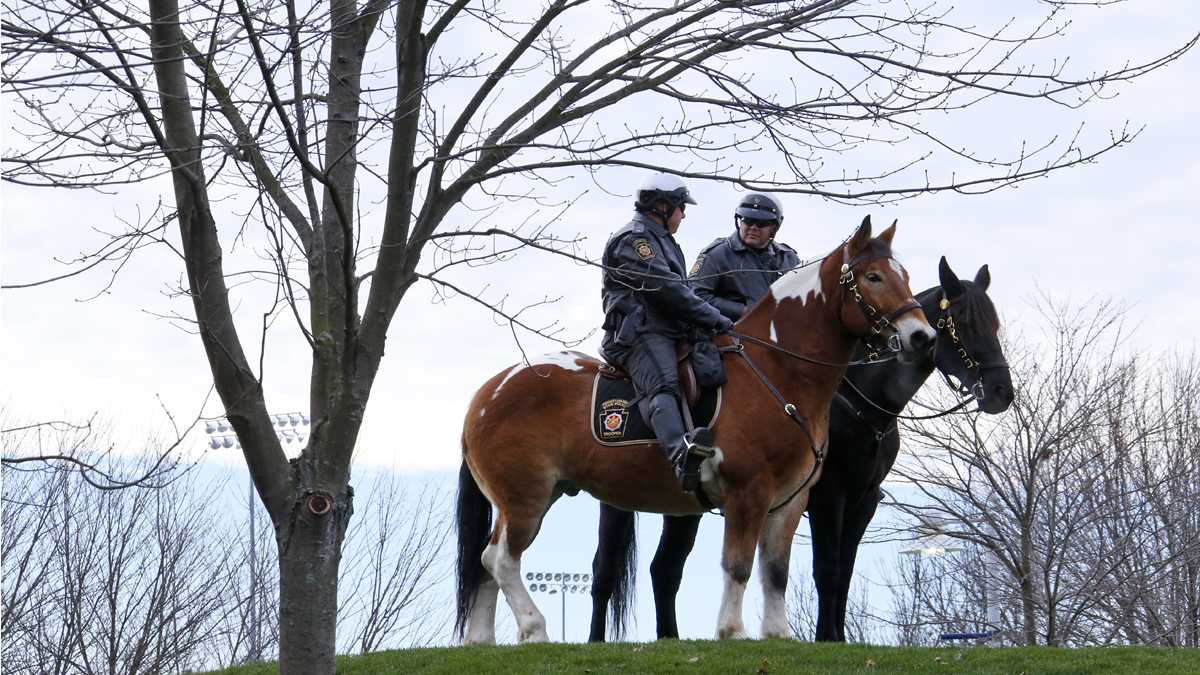 Pennsylvania State Police on horses outside Beaver Stadium before an NCAA college football game between the Penn State and the Michigan State in State College, Pa. (AP File Photo/Gene J. Puskar) 