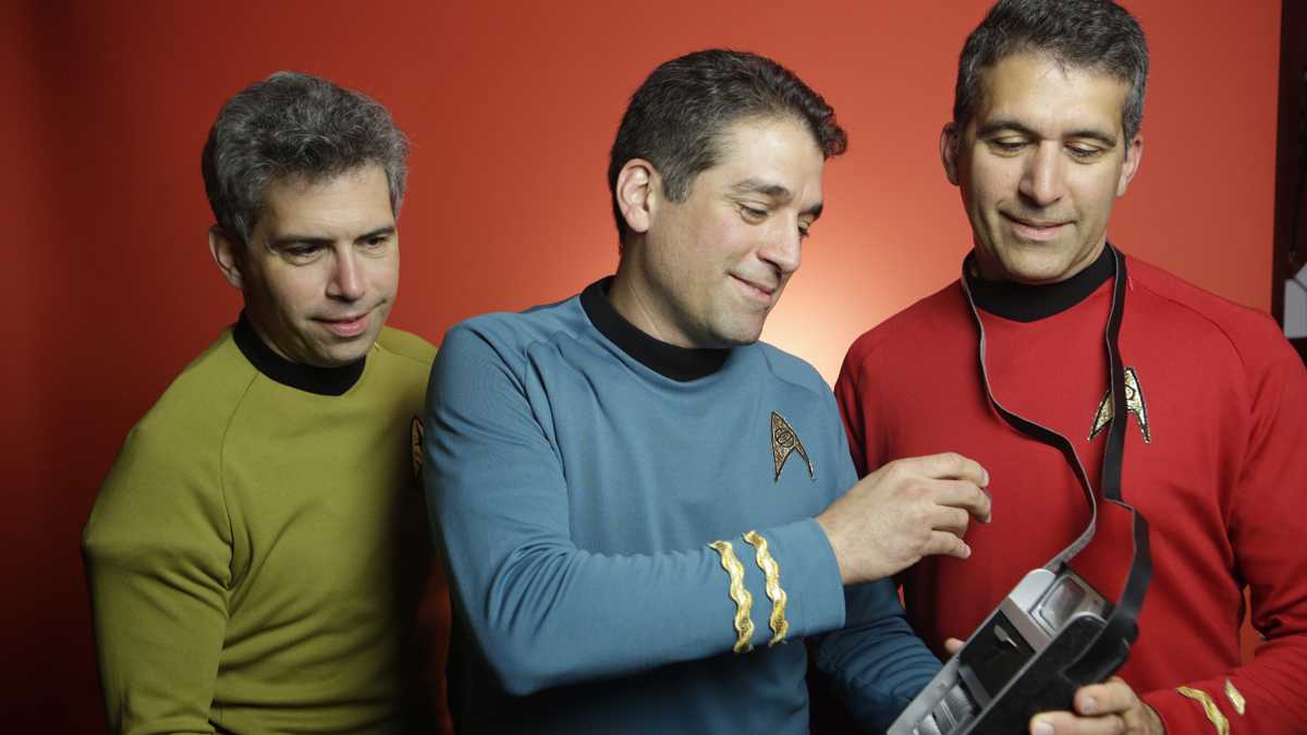  Members of the Final Frontier Medical Devices team geeked out in Star Trek gear, with the fictional device that inspired the Qualcomm Tricorder XPRIZE. From left: brothers George, Basil and Gus Harris. (Not pictured: Phil Charron, Julia Harris, Andy Singer and Ed Hepler.) (Photo courtesy of XPRIZE) 