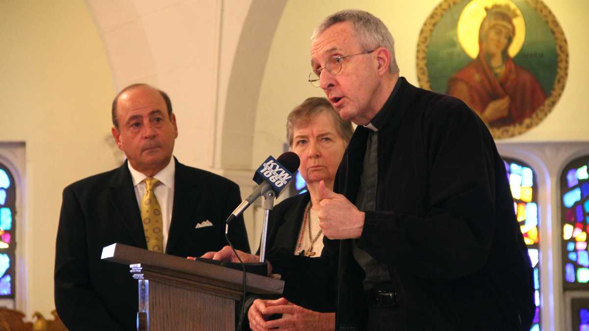  The Rev. James Connell, right, and Sister Maureen Paul Turlish of Catholic Whistleblowers call for justice for victims of sexual abuse. The are joined by Arthur Baselice Jr., whose son was sexually abused by two clergy members at Archbishop Ryan High School. (Emma Lee/WHYY)  