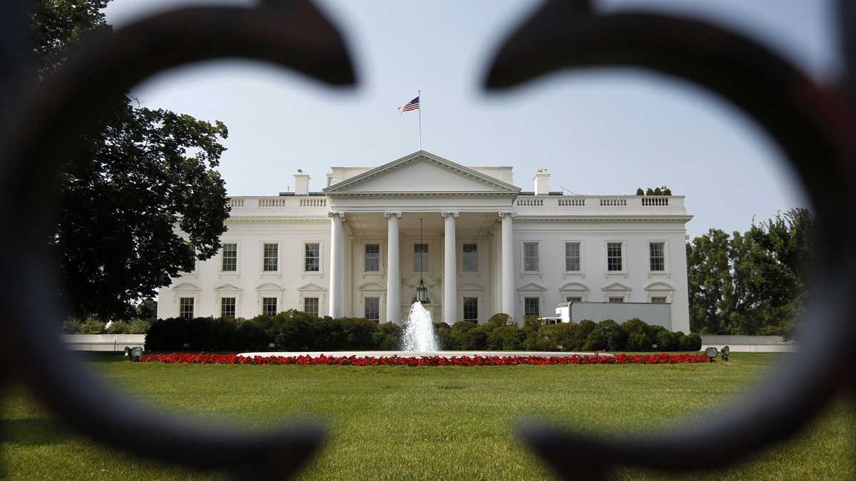 The White House can be seen through a fence