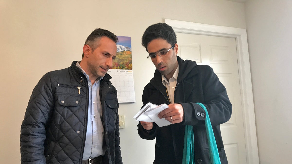  Imad Ghajar (left), a Syrian refugee, reviews paperwork with Amer Alfayadh, caseworker for Church World Service’s, in Lancaster, Pennsylvania. (Emily Previti/WITF) 