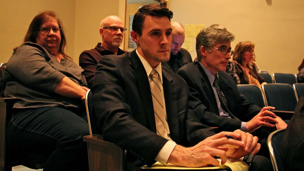 Lawyers for the plaintiff in Doe vs. BASD Jeremy Samek (center) and Randall Wenger (right) listen to public testimony on a resolution to comply with demands that students be restrictied to using restrooms and locker rooms based on their biological sex. (Emma Lee/WHYY)