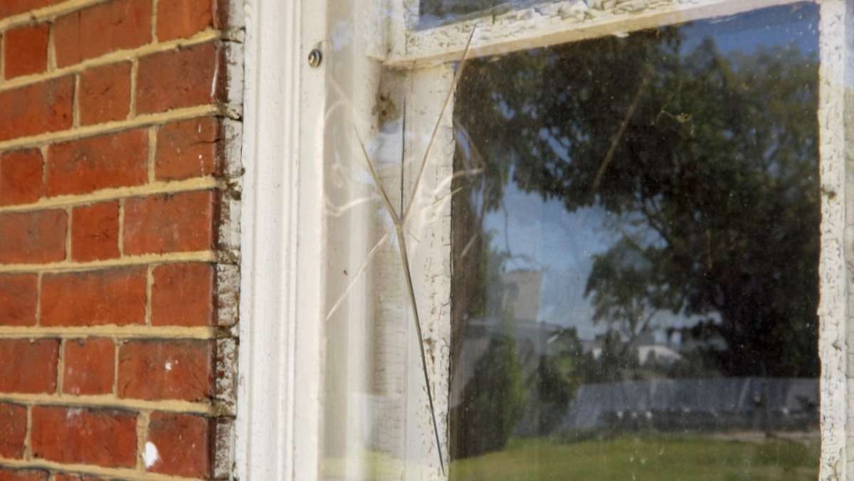 A crack in the plexiglass window covering.