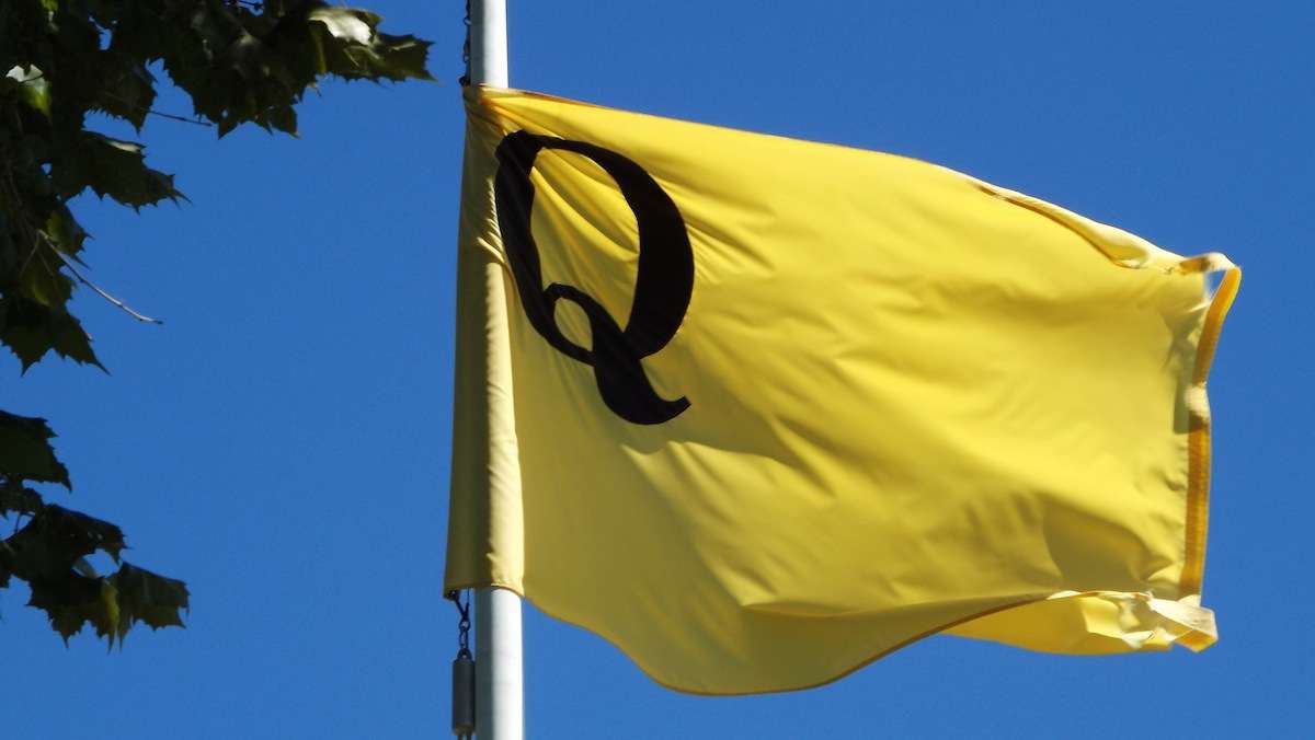 'Q' for quarantine.  The flag is an accurate replica of those used to signal ships into the docks for yellow fever inspection.