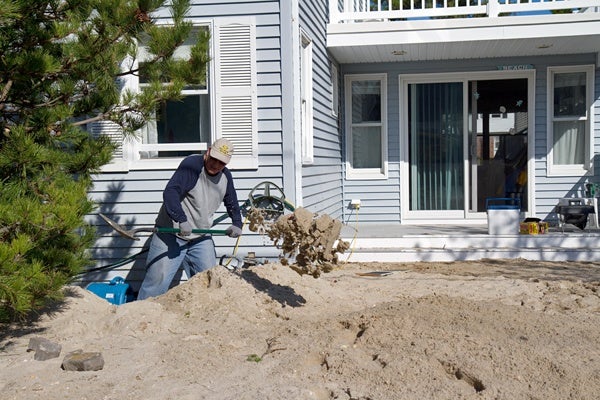 <p><p>Hank Ludington digs out his home from about four feet of sand on Long Beach Island after Hurricane Sandy. (Lindsay Lazarski/WHYY)</p></p>
