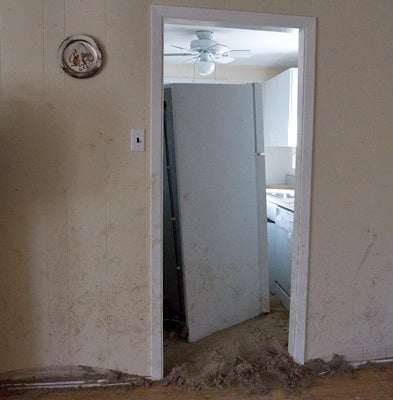 <p><p>Mounds of sand and the refrigerator block the entrance way into the kitchen. (Lindsay Lazarski/WHYY)</p></p>
