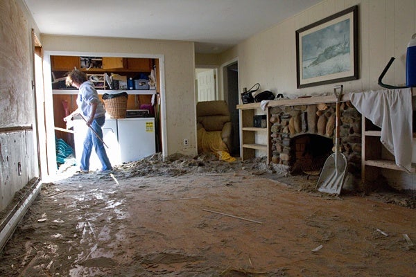 <p><p>Trish Hosmer removes pieces of broken furniture from her living room after Hurricane Sandy. (Lindsay Lazarski/WHYY)</p></p>
