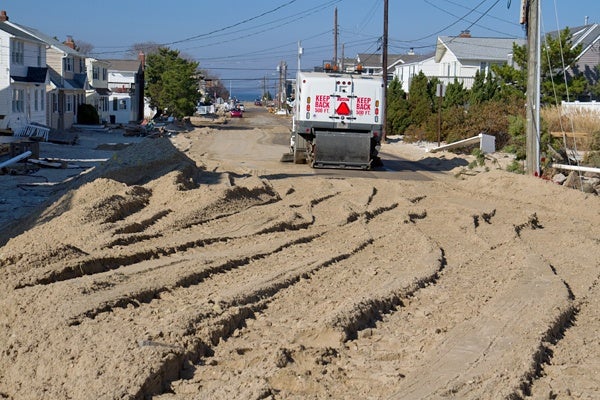 <p><p>Sand is cleared from a street on Long Beach Island nearly two weeks after Hurricane Sandy. (Lindsay Lazarski/WHYY)</p></p>
