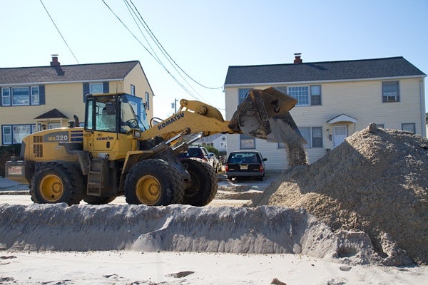 <p><p>Bulldozers remove sand from a street near Brighton Beach on Long Beach Island. (Lindsay Lazarski/WHYY)</p></p>
