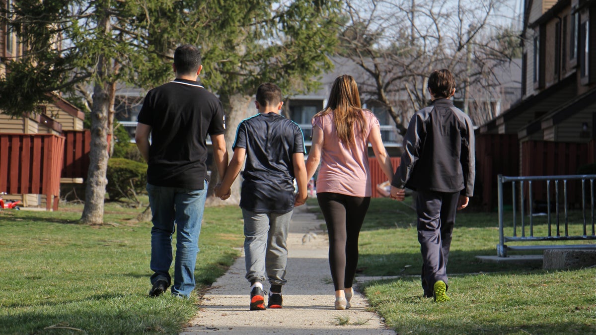 A Costa Rican family walks near their home in South Jersey. (Emma Lee/WHYY)