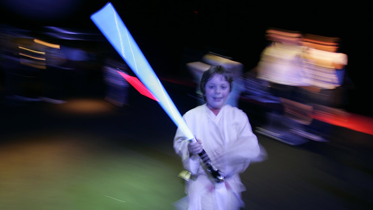  A young boy is shown holding his light sabre at a 2007 Star Wars-themed event in London. (AP Photo/Alastair Grant, file) 