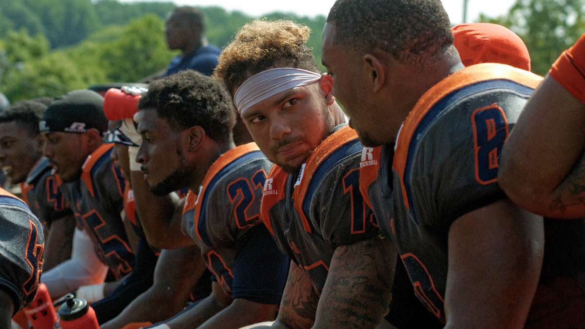 Lincoln footbal players confer on the bench during the contest against Cheyney. (Bastiaan Slabbers/for NewsWorks)