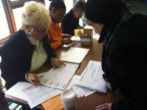 <p><p> </p>
<p>A poll worker at Lingelbach Elementary had a hard time finding one voter's name on the list because her ID spells it differently than what they had recorded. The voter, Ruth, says sometimes her last name is spelled in German and other times, it's not. She was still able to vote. (Kiera Smalls/for NewsWorks)</p></p>
