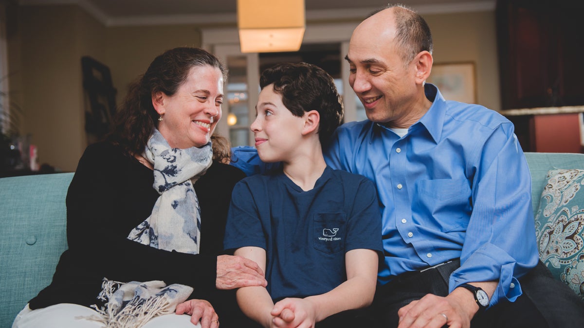  The author and her husband are shown with their son. (BG Productions) 