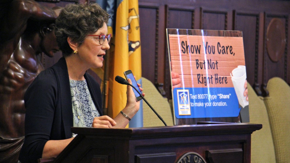  Liz Hersh, director of the Office of Homeless Services, urges Philadelphians to use their phone to the Mayor's Fund to End Homelessness rather than hand cash to panhandlers. (Emma Lee/WHYY) 
