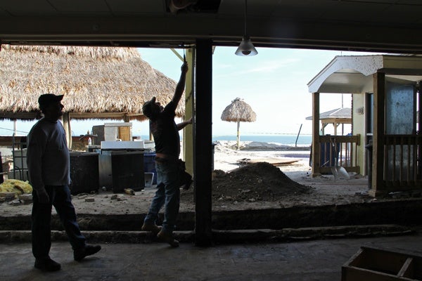 <p><p>Workers clean up the damaged Sea Shell Resort and Beach Club in Beach Haven, N.J. The club's owner said he objected to dune building because it spoiled the view. (Emma Lee/for NewsWorks)</p></p>
