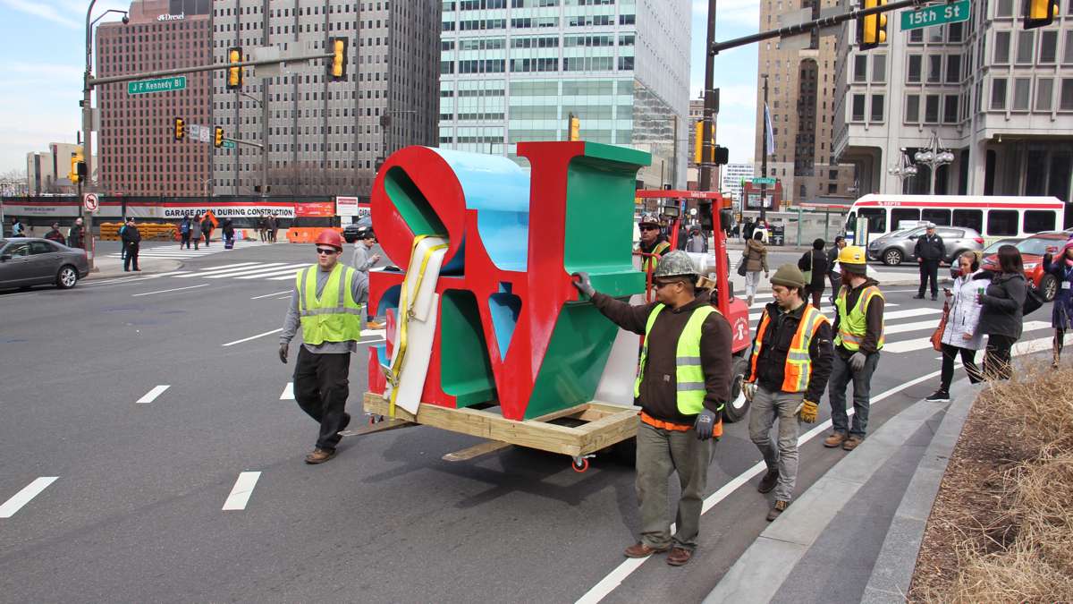 Workmen escort the sculpture onto 15th Street.
