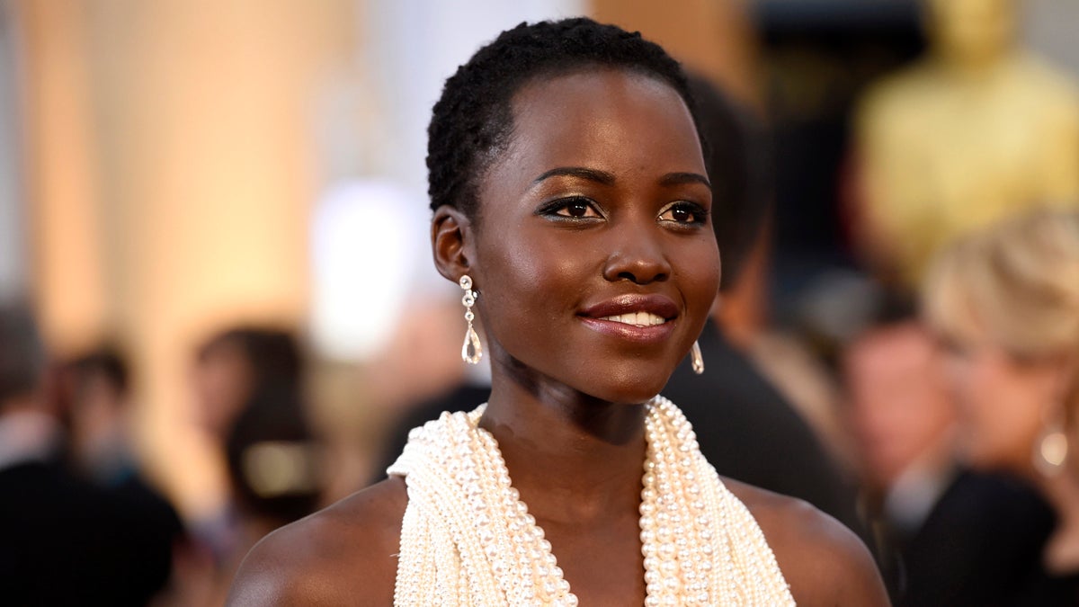 Lupita Nyong'o arrives at the Oscars on Sunday, Feb. 22, 2015, at the Dolby Theatre in Los Angeles. (Photo by Chris Pizzello/Invision/AP)