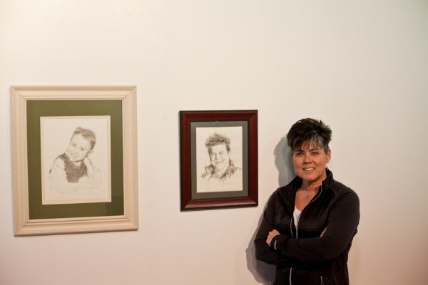 <p><p>Loraine Dunn, art director for Mt. Airy Art Garage, standing next to her drawings, "Young Jerry" (left) and "Kathryn." (Brad Larrison/for NewsWorks)</p></p>
