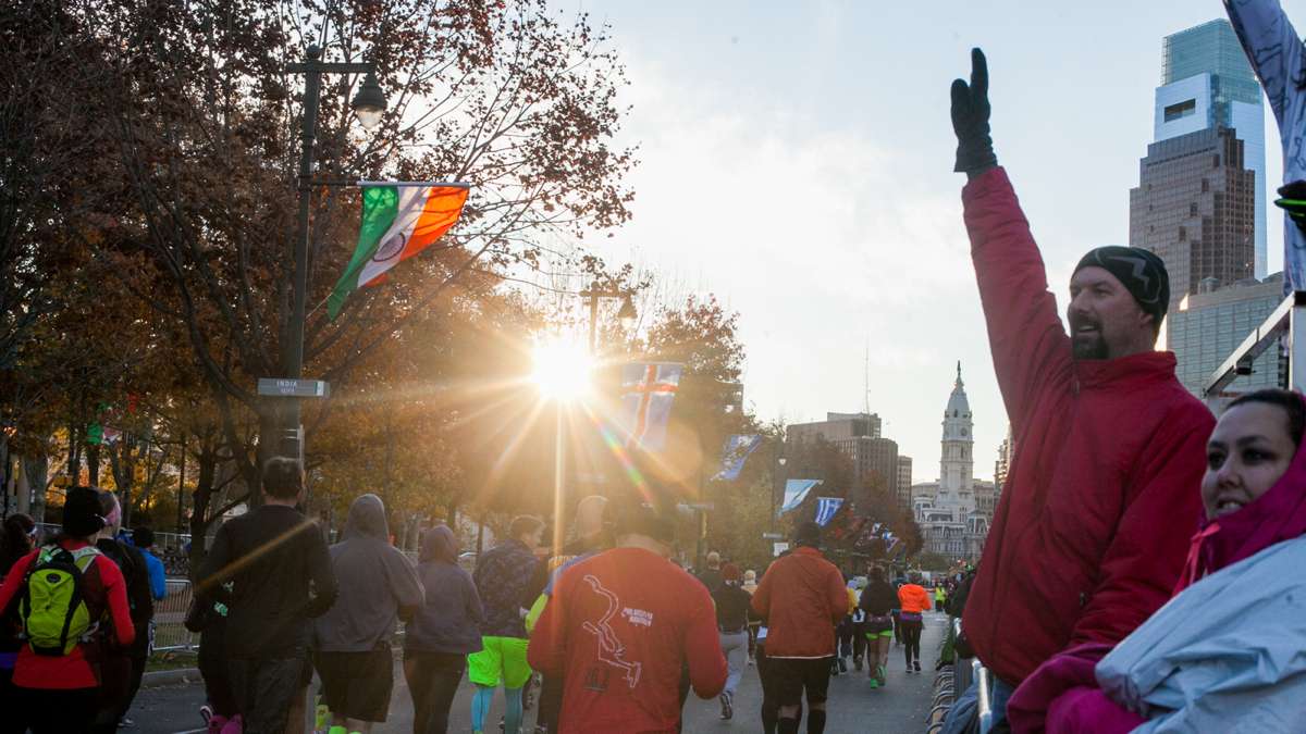 Spectators cheer on runners as the Philadelphia Marathon begins Sunday morning.