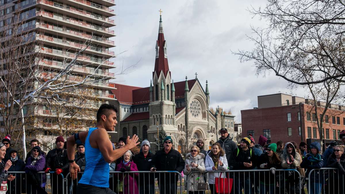 Spectators cheer as runners approach the finish line of the Philadelphia Marathon.