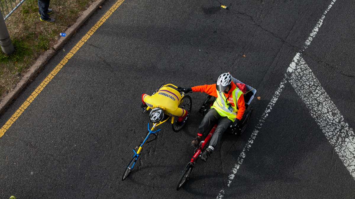 A wheelchair athlete gets a helping hand on the way to the finish line.