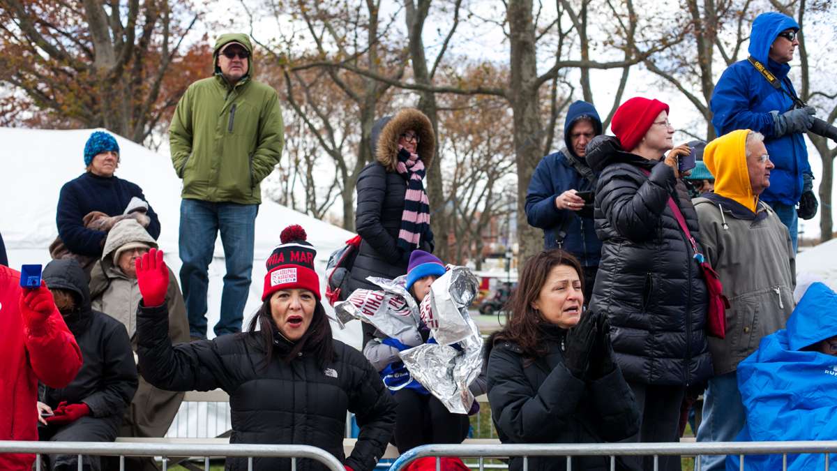Bundled up spectators cheer for runners on a blustery day at the Philadelphia Marathon.