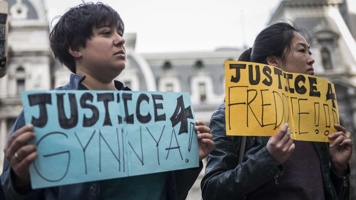 Dimi Xepapadeas (left) and Victoria Yu hold signs seeking justice for Gynnya Mcmillen and Freddie Gray, both of whom were young African Americans that died in police custody. When asked about what drew her to the case of Freddie Gray, Yu said, 'For me it’s very clearly an injustice and needs to be spoken about.'