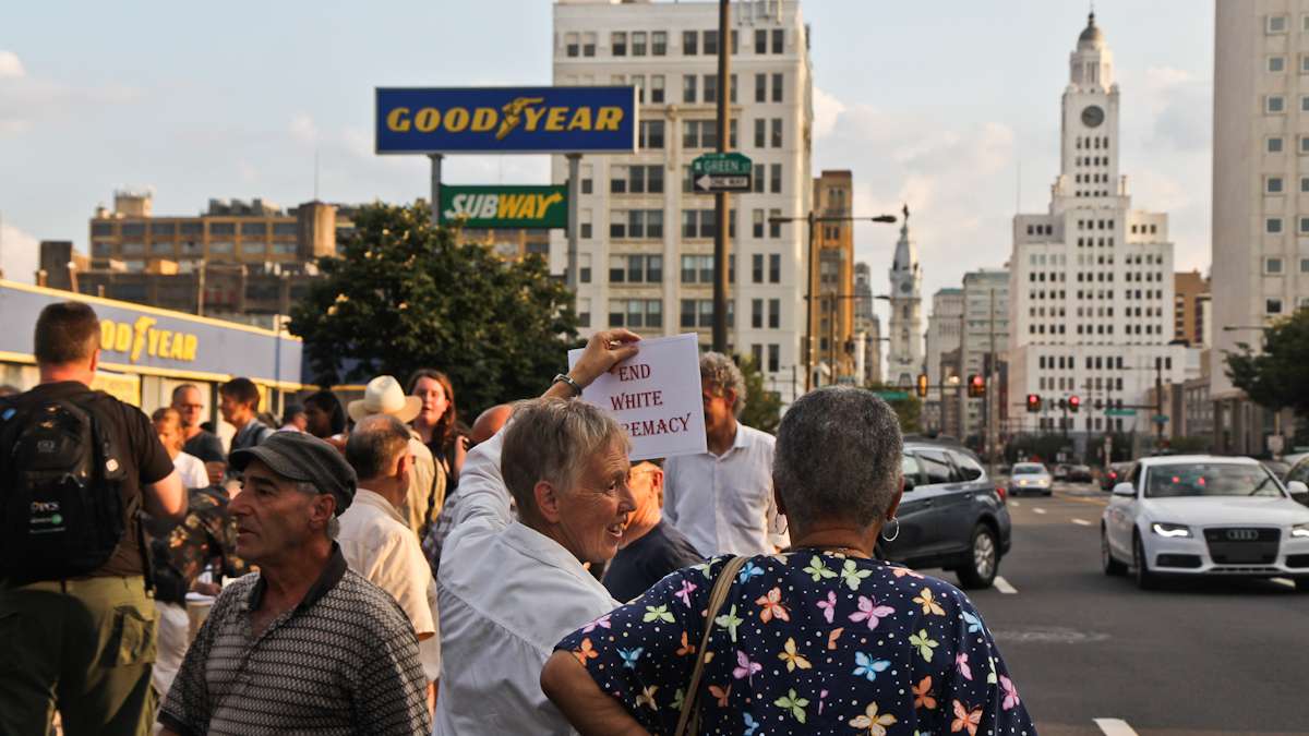Marion Brown receives honks from motorists with her ‘end white supremacy sign at the Philly is Charlottesville march Wednesday evening. (Kimberly Paynter/WHYY)