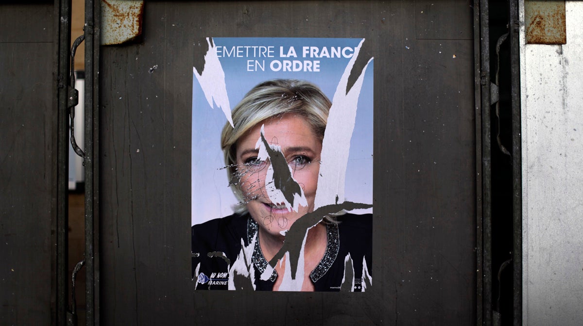  A torn poster showing a portrait of far-right leader and candidate for the 2017 French presidential election Marine Le Pen is seen outside at a polling station in Paris, Sunday, April 23, 2017. (AP Photo/Emilio Morenatti) 