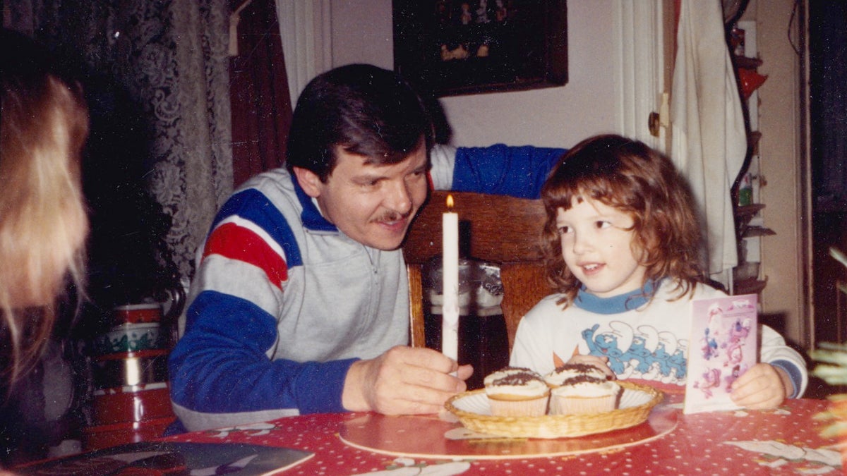  The author celebrates her 5th birthday. Her Dad, James Rusek, is holding the candle. (Image courtesy of Marta Rusek) 