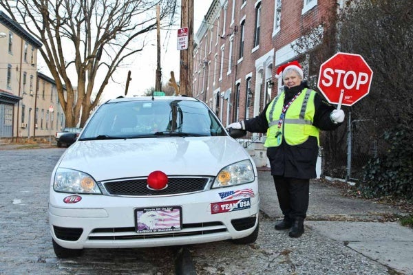 <p><p>Nominated Crossing Guard Mary Evans stands with her car decked out as Rudolph at Hermitage and Smick streets in Manayunk. (Kimberly Paynter/WHYY)</p></p>
