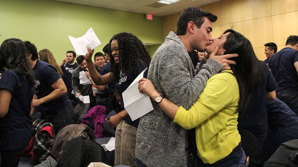  Kelsie Persaud and her fiancé celebrate Persaud's match for her residency. (Kimberly Paynter/WHYY) 