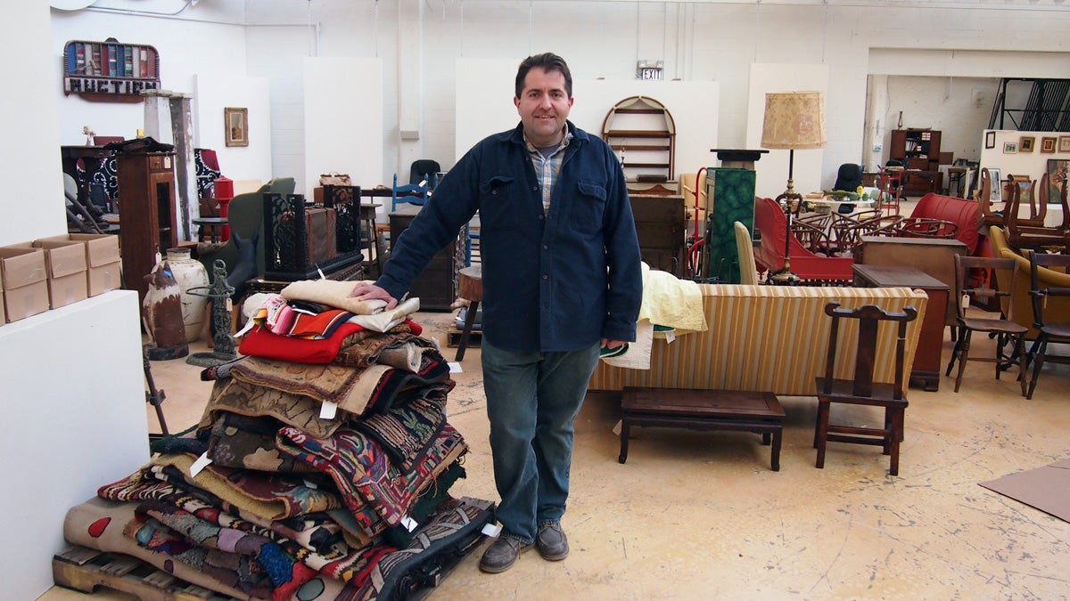  Alex Stanku manages the auctions at Material Culture in the East Falls neighborhood of Philadelphia. (Shai Ben-Yaacov/WHYY) 