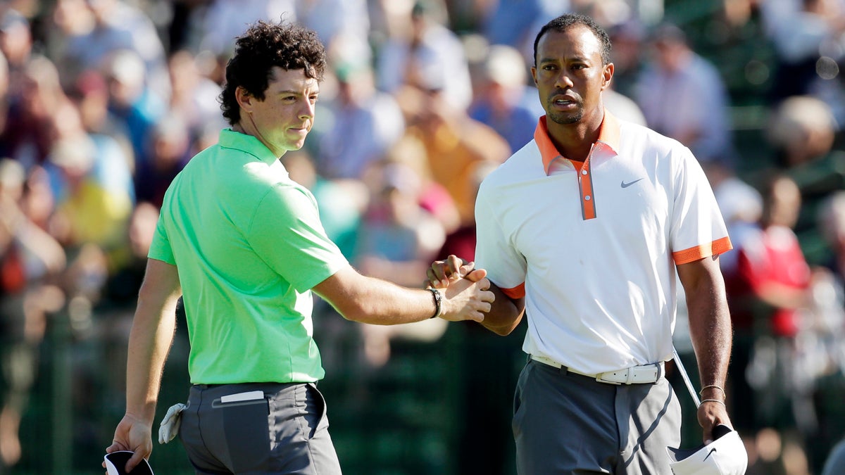  Rory McIlroy, left, of Northern Ireland, and  Tiger Woods shake hands on the 18th green during practice for the U.S. Open golf tournament at Merion Golf Club, Wednesday, June 12, 2013, in Ardmore, Pa. (AP Photo/Charlie Riedel) 