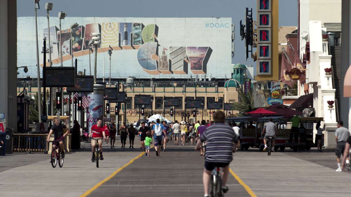 People ride bikes and walk the Atlantic City boardwalk Memorial Day weekend, Saturday, May 28, 2016.