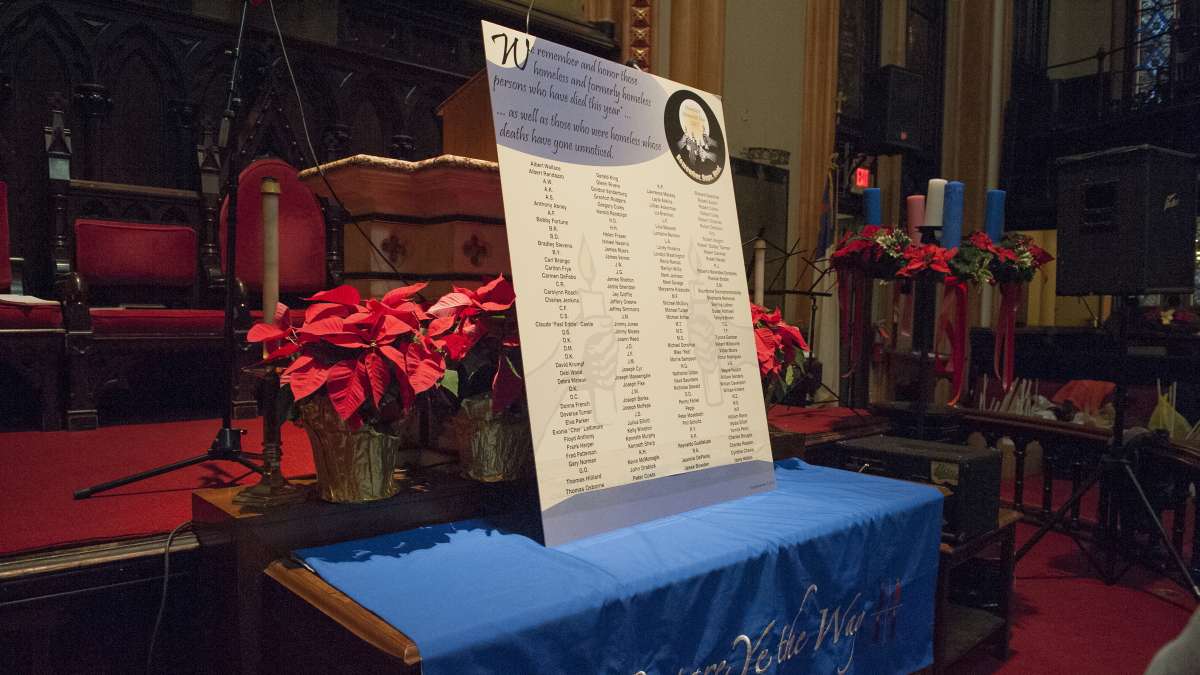 A sign with the names of more than 100 deceased homeless men and women sits on the altar of the Arch Street United Methodist Church. (Jonathan Wilson/for NewsWorks)