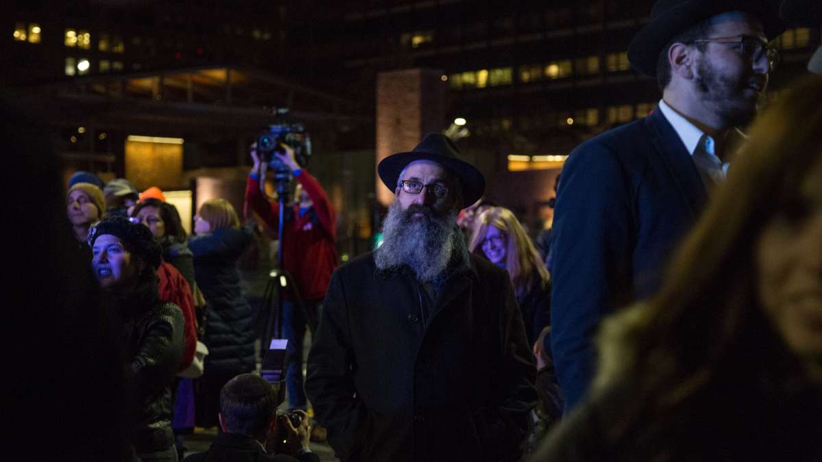 A crowd gathers on Market Street to watch the lighting of the massive menorah on Independence Mall for the third night of Hanukkah, December, 26, 2016.